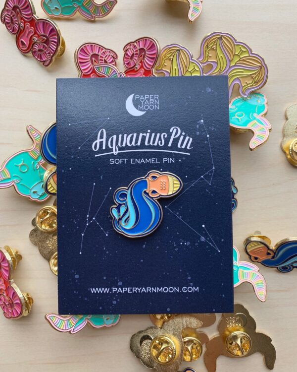 Aquarius pin featuring traditional symbol of water flowing out of a vase.