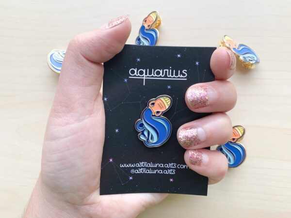 Aquarius Pin by Astraluna Arts. Aquarius pin with blue and gold enamel.
