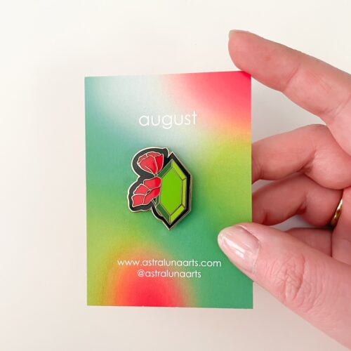 August birth month with red poppy flower and traditional stone of peridot in gold enamel. Pin set in card with red and green card ready to gift.