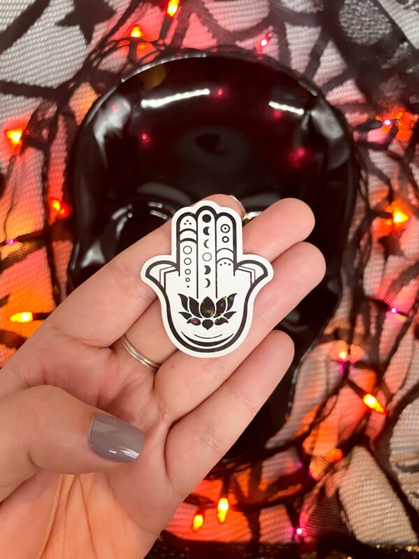 Black and white hamsa sticker with iridescent finish with Halloween background.