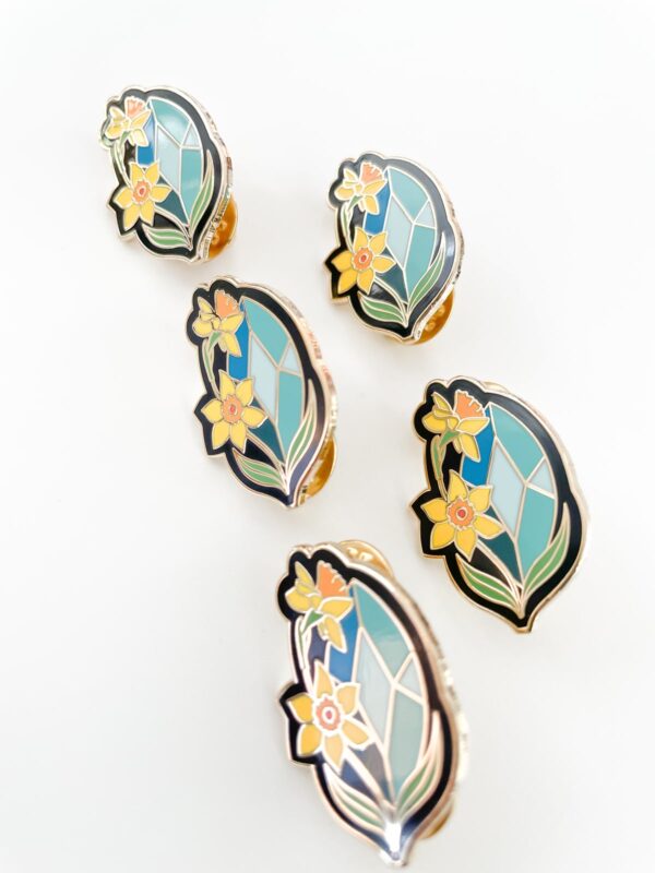 Aquamarine and Daffodils pin representing March birthstone.