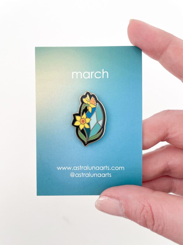 Aquamarine and Daffodils pin representing March birthstone.