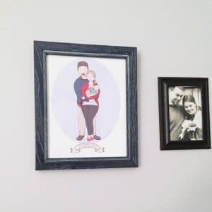 Hugging family custom print with dark frame on wall.