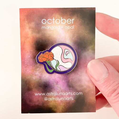 October birth month pin ready to gift. Marigold flower and opal stone design on gold enamel pin by astraluna arts. Pin on card.