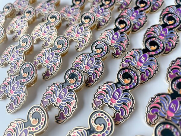 Scorpio pin with bright pink and purple with black. Gold enamel scorpio pins.