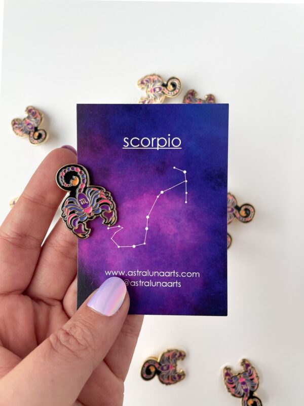 Scorpio pin with bright pink and purple with black. Gold enamel scorpio pin with astrology card backing.
