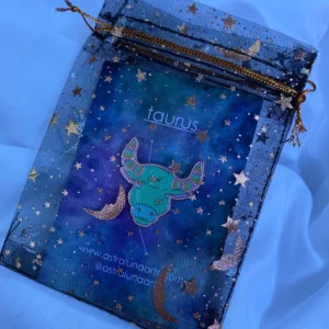 Pastel colored Taurus pin in star filled packaging.