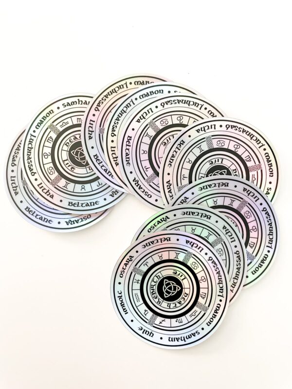 Holographic Wiccan Wheel Sticker on white table.