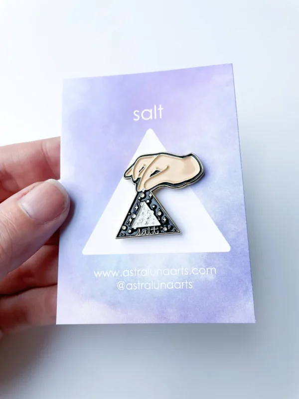 Salt pin on lavender card backing.